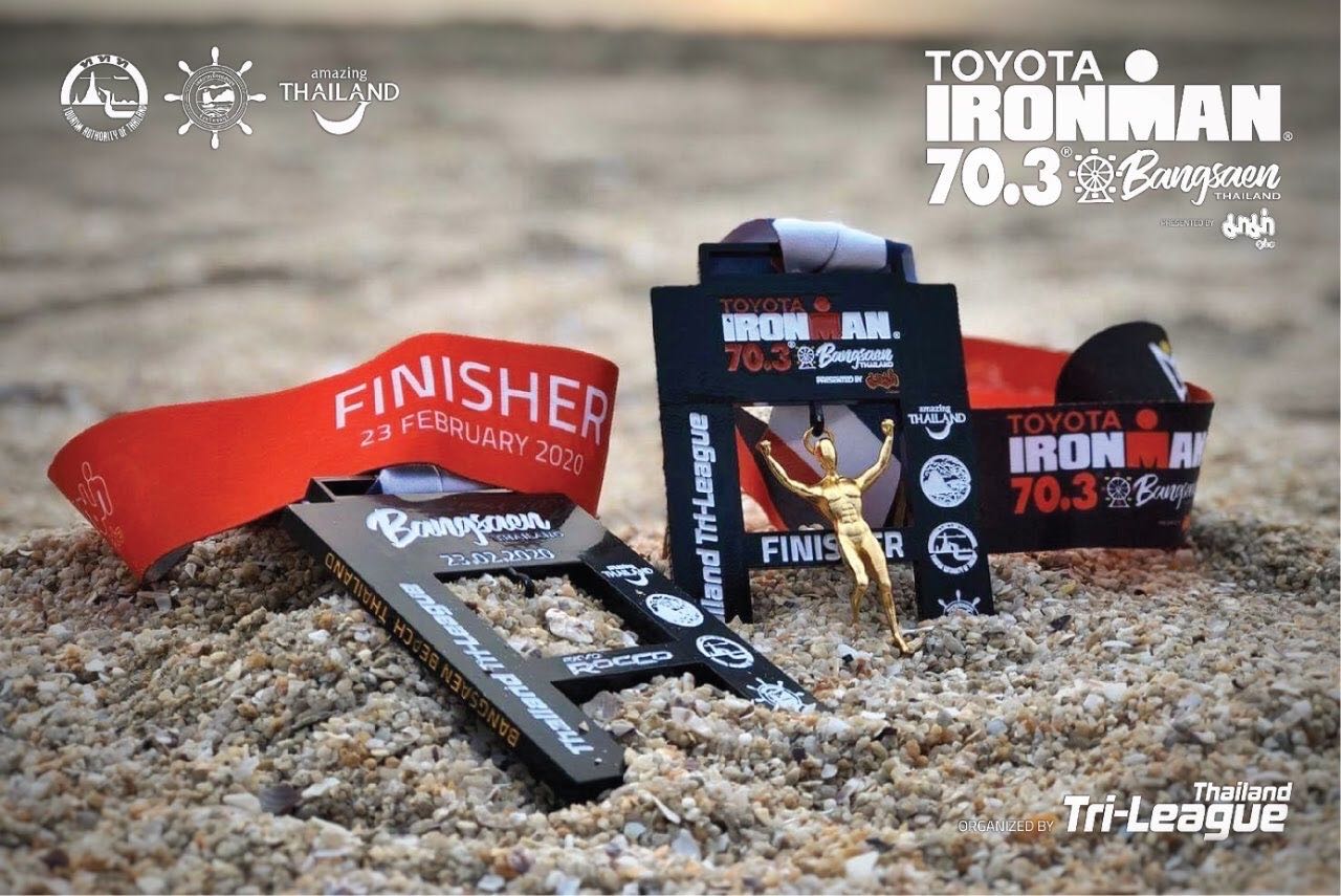 Custom Bangsaen 2020 finisher medals photographed on the beach